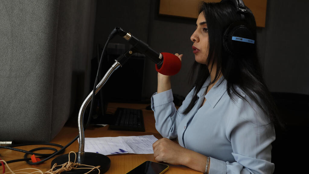 Palestinian journalist Rewaa Mershid works at the studio of ZMN FM radio station in Gaza City 
