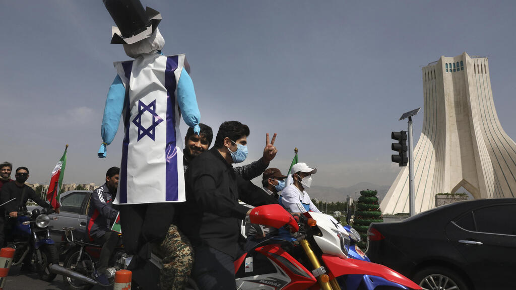 Pinhata covered by an Israeli flag during a parade in Iran (Photo: AP) Pinhata covered by an Israeli flag during a parade in Iran