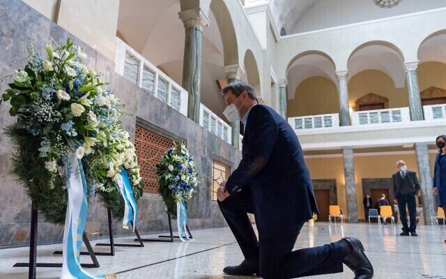 Bavaria's State Prime Minister Markus Soeder lays a wreath of flowers during a commemoration on the occasion of the 100th birthday of anti-Fascist Sophie Scholl, who was killed by the Nazi regime in 1943, in the staircase of Ludwig Maximilian University in Munich 