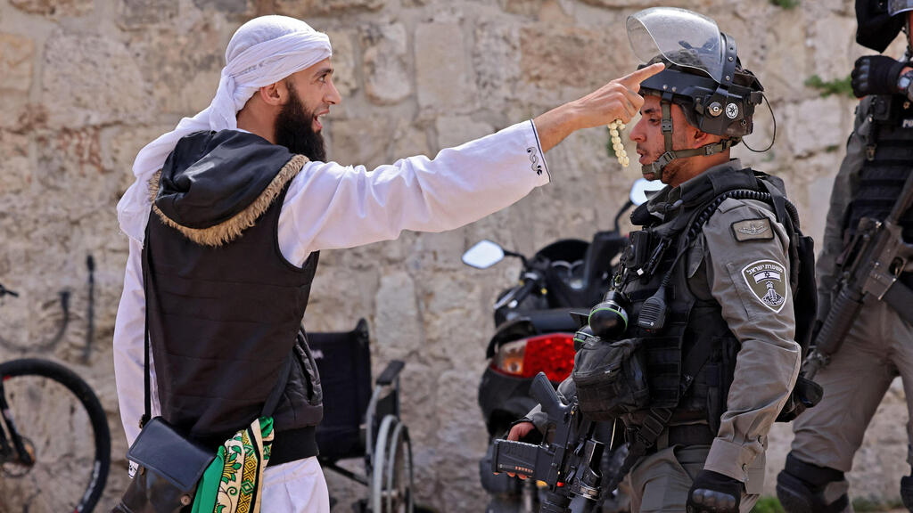 A Palestinian argues with a Border Police officer in the Old City of Jerusalem, May 10, 2021 