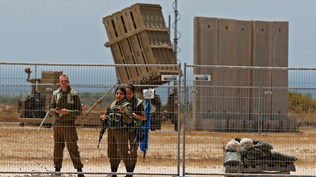 IDF soldiers stand next an Iron Dome battery close to the Gaza border 