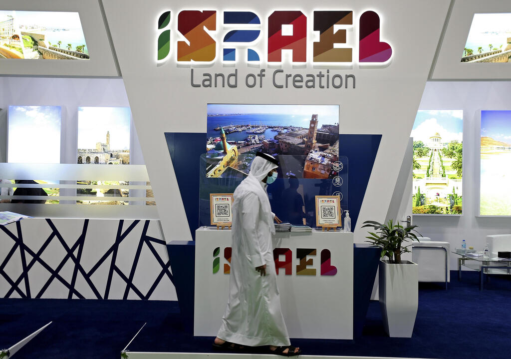 A man passes by the Israel stand on the opening day of the Arabian Travel Market exhibition, in Dubai, United Arab Emirates, Sunday, May 16, 2021