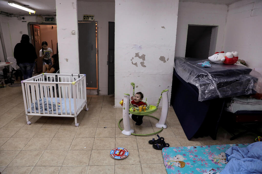 Israelis stay inside a bomb shelter as Israeli-Palestinian cross-border violence continues, in Ashkelon, southern Israel 