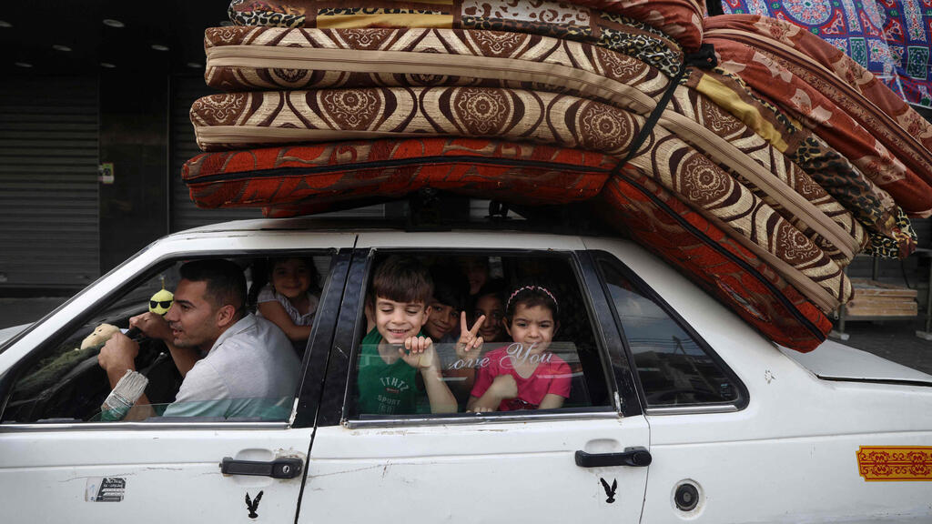 A Gaza family returns home on Friday after the ceasefire with Israel took effect 