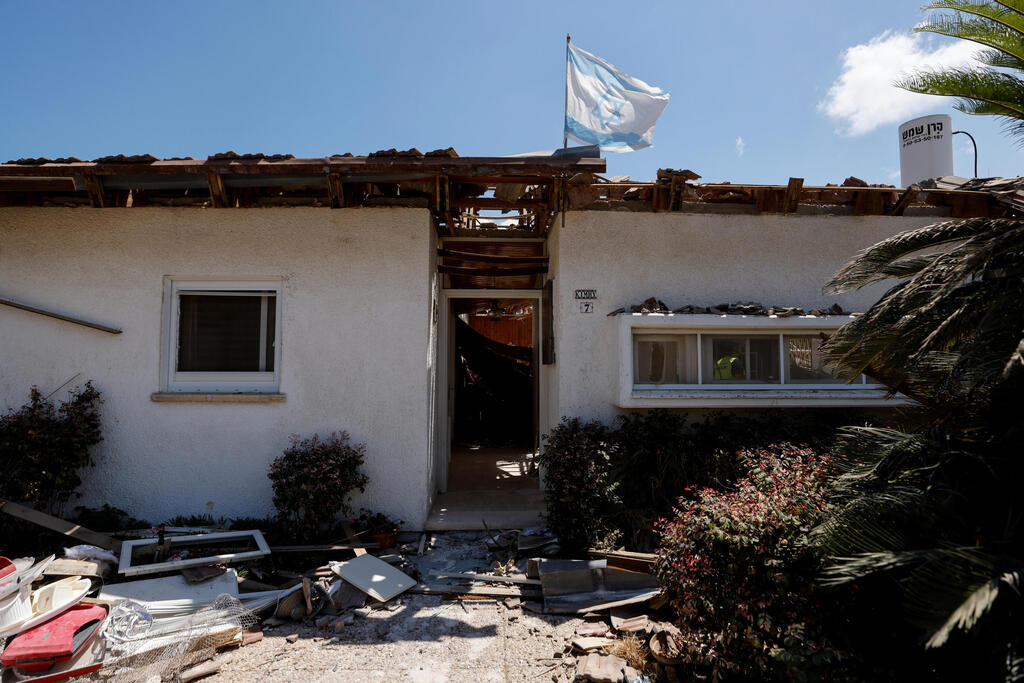 The home of Uri Kimchi with an Israeli flag after being destroyed by rocket fire from Gaza earlier this month 