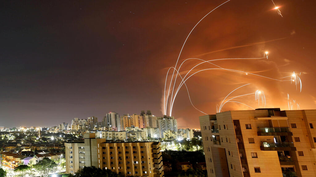 Streaks of light are seen as Israel's Iron Dome anti-missile system intercept rockets launched from the Gaza Strip towards Israel, as seen from Ashkelon, 