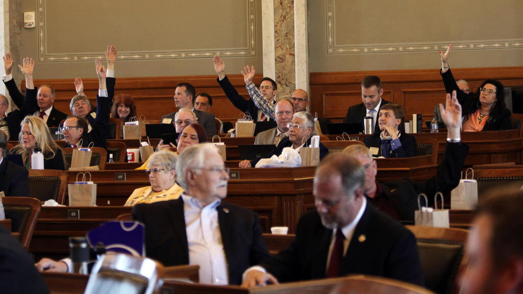 Republicans in the Kansas House raise their hands to force a roll-call vote on a resolution expressing solidarity with Israel and condemning Hamas militants following their recent war in the Gaza Strip, Wednesday, May 26, 2021
