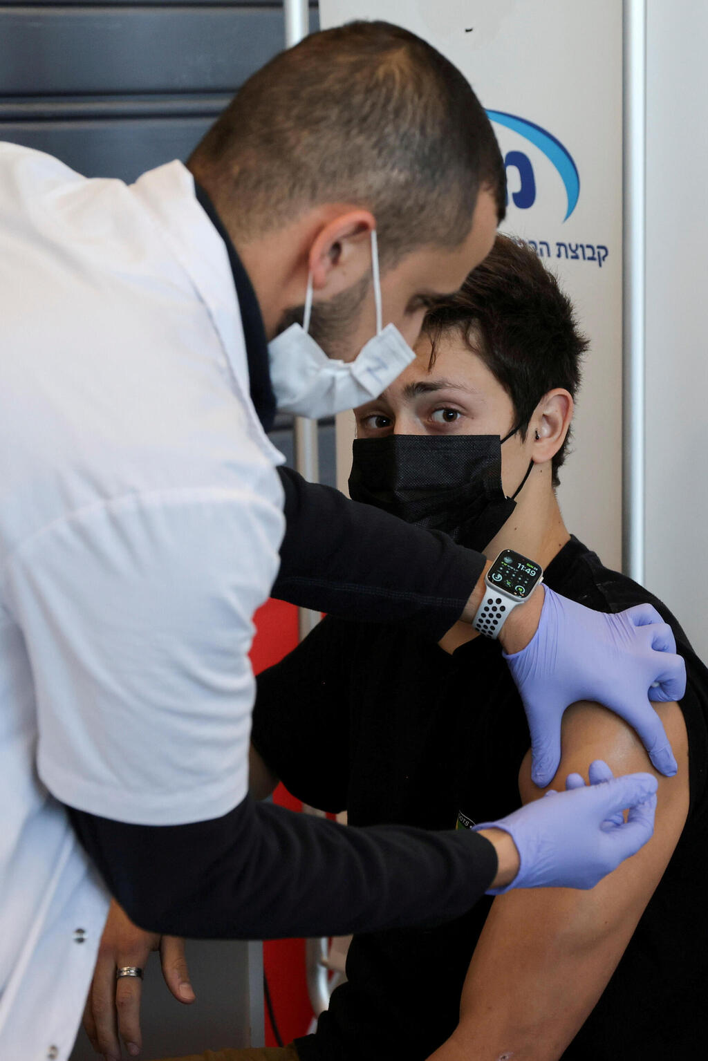 A teenager receives a vaccination against the coronavirus in Tel Aviv, Israel 
