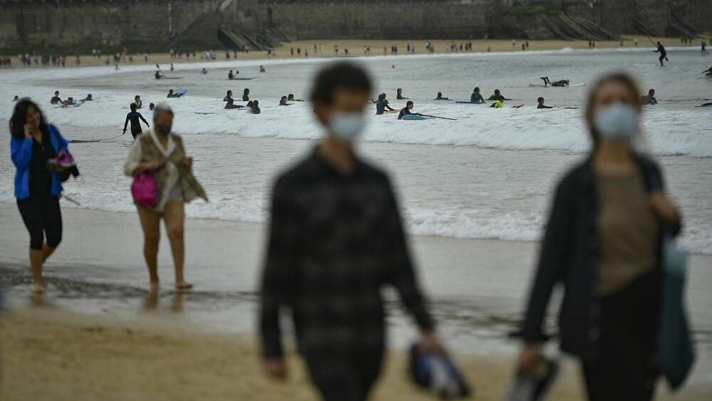  people walk along La Concha beach, after lockdown restrictions were lifted, in San Sebastian, northern Spain