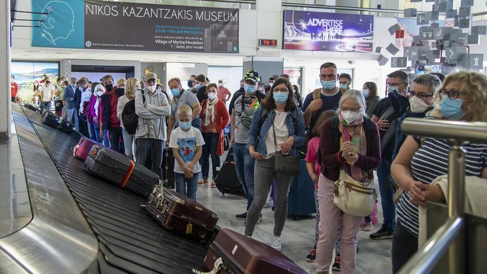 o, passengers from Hanover wait to pick their luggage at Nikos Kazantzakis International Airport in Heraklion, on the island of Crete, Greece