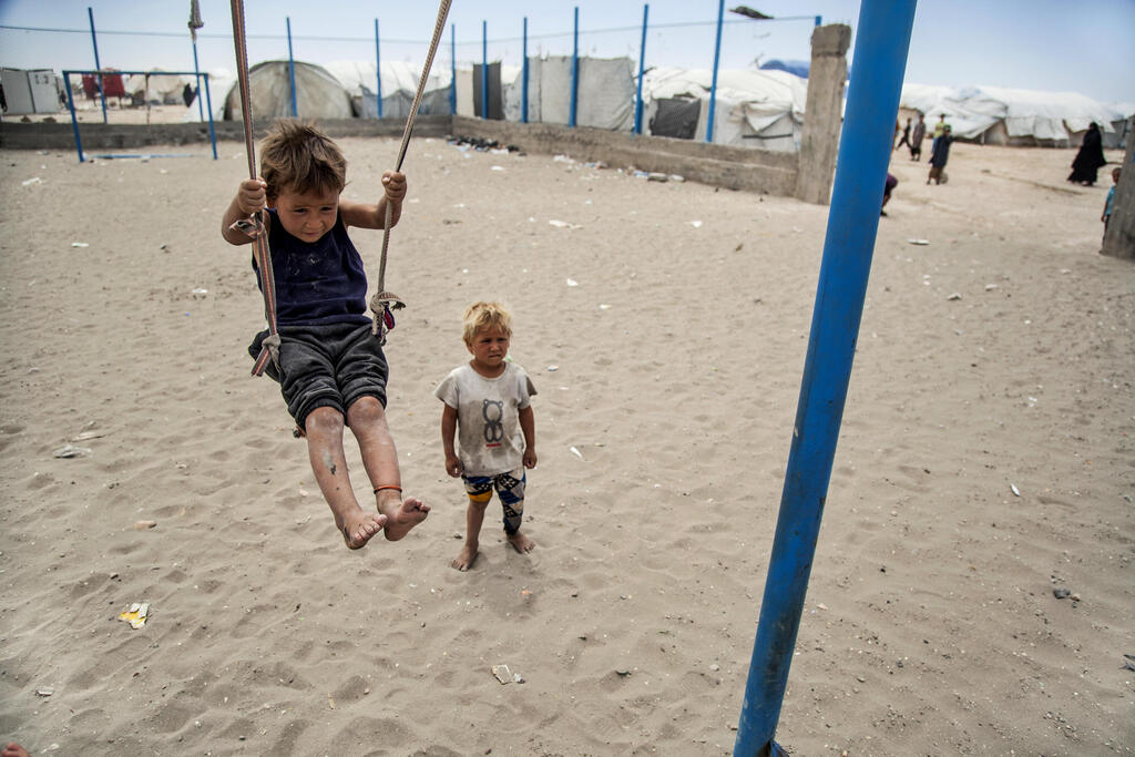 A boy plays on a swing at al-Hol camp, which houses families of members of the Islamic State group, in Hasakeh province, Syria, Saturday, May 1, 2021