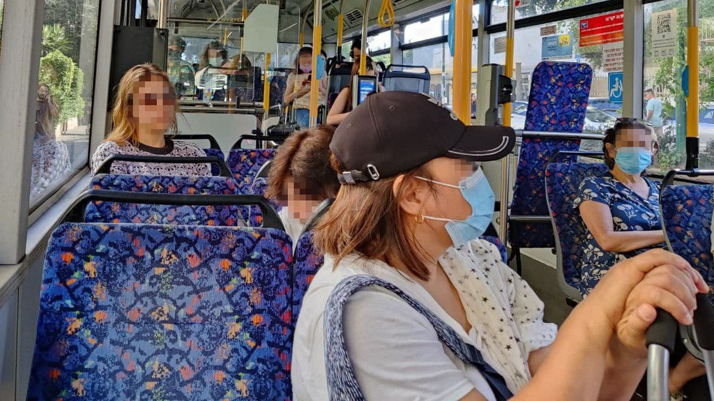 Passengers wearing masks on an Israeli bus  