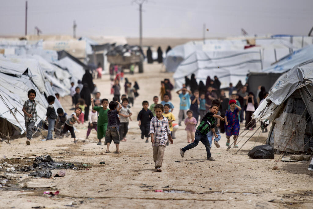 Children gather outside their tents, at al-Hol camp, which houses families of members of the Islamic State group, in Hasakeh province, Syria, Saturday, May 1, 2021