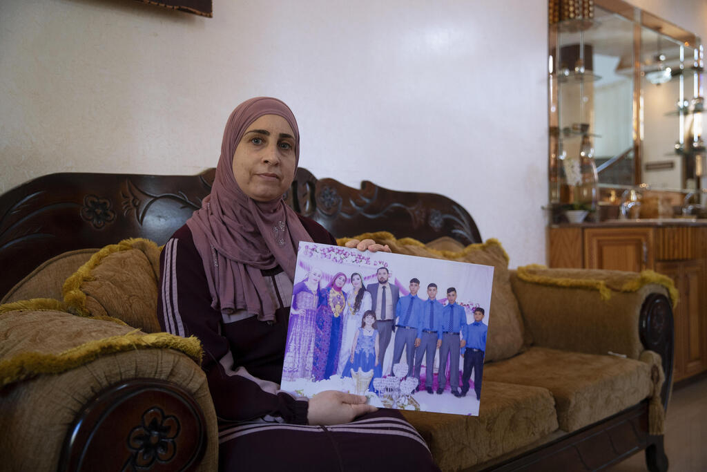 Sanaa Shalaby, displays picture with estranged husband Muntasser Shalaby in her home on the West Bank 