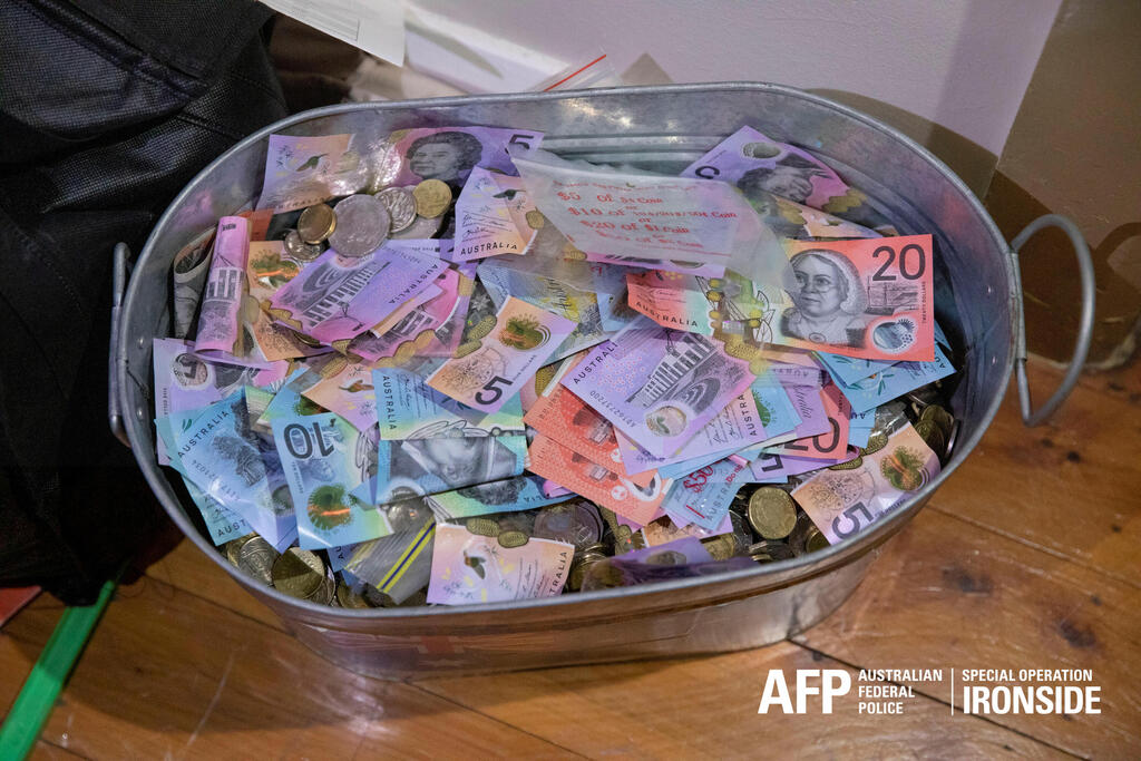 Money seized by Australian Federal Police are seen after its Operation Ironside against organized crime 