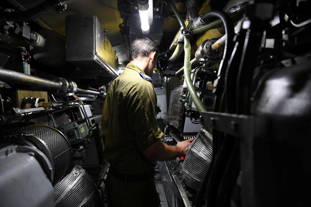 The chief machinist of Israeli navy submarine Leviathan takes a Reuters correspondent on a tour of the engine room during a sailing in the Mediterranean Sea off the coast of Haifa, northern Israel 