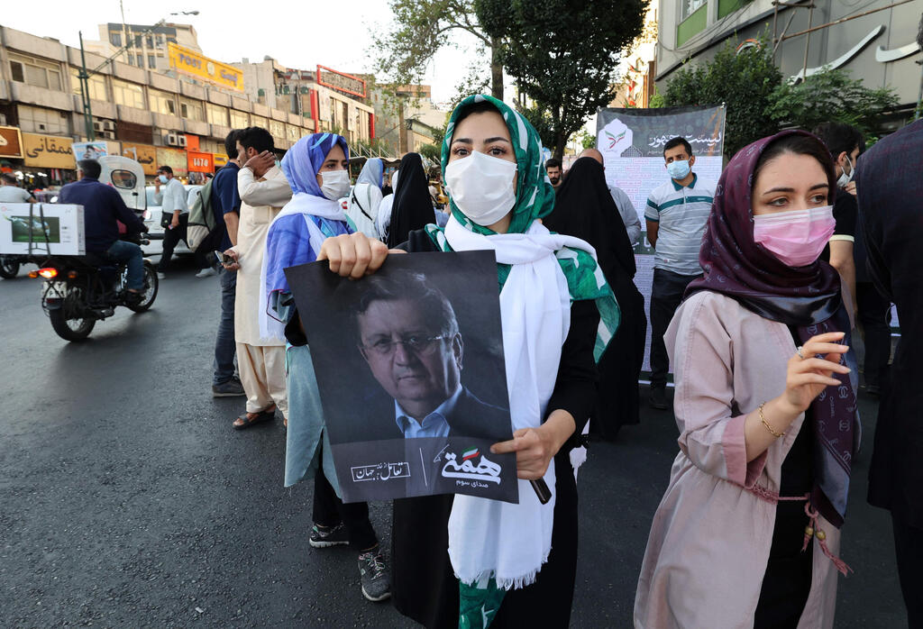 Hemmati supporter holds his portrait during a rally in the Iranian capital Tehran, June 15, 2021