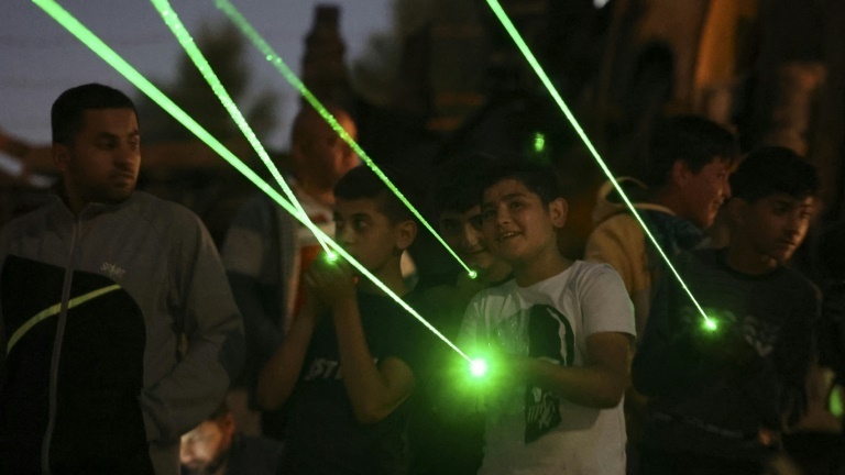 Lasers are directed towards the windows of homes in the settlement