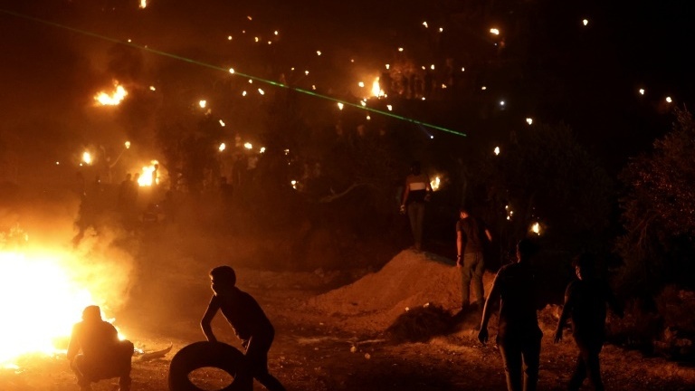 The protesting Palestinians burn tyres and the prevailing wind takes the acrid smoke towards the newly established Eviatar settlement