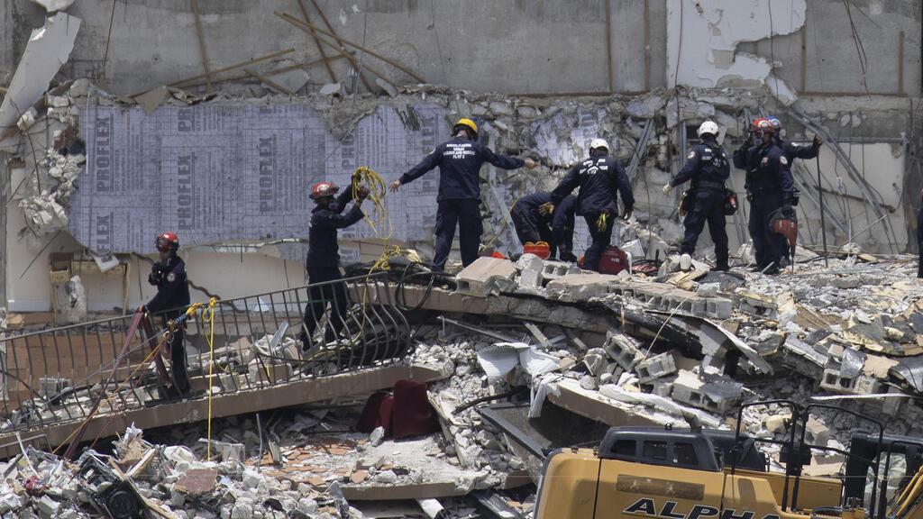  Rescue workers search for survivors at site of condominium tower collapse near Miami 
