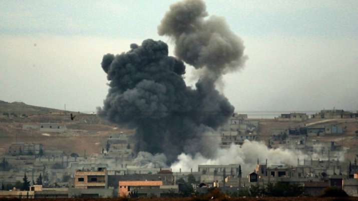 hick smoke rises following an airstrike by the US-led coalition in Kobani (Syria