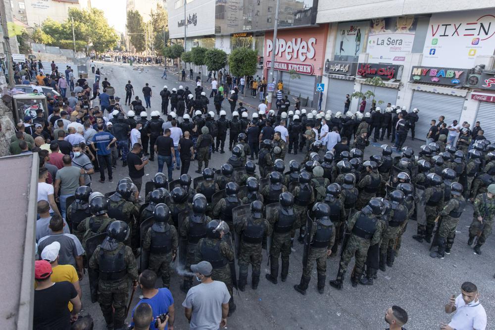 alestinian riot police and security officers in plainclothes clash with demonstrators following a rally protesting the death of Palestinian Authority outspoken critic Nizar Banat