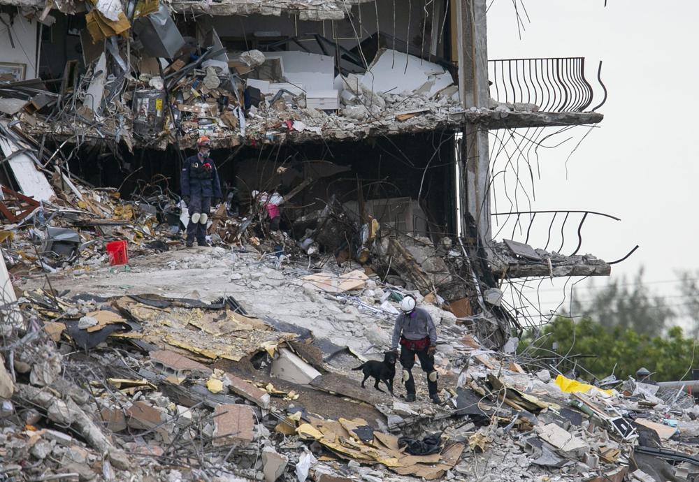 South Florida Urban Search and Rescue team look through rubble for survivors at the partially collapsed Champlain Towers South condo building in Surfside, Fla 