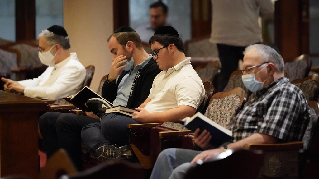 Jewish faithful pray at the Shul of Bal Harbour after members of the community were reported missing in the partial collapse of a 12-story beachfront condo 