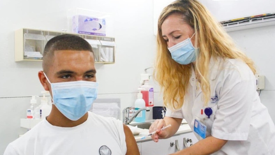 An Israeli teen receives his coronavirus vaccine at a clinic in the northern city of Haifa (Photo: Ido Erez) מתחסנים