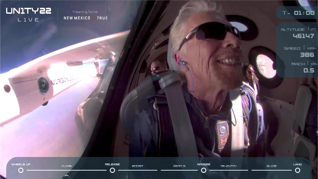 Billionaire Richard Branson smiles on board Virgin Galactic's passenger rocket plane VSS Unity before starting its untethered ascent to the edge of space above Spaceport America near Truth or Consequences, New Mexico, U.S. July 11, 2021