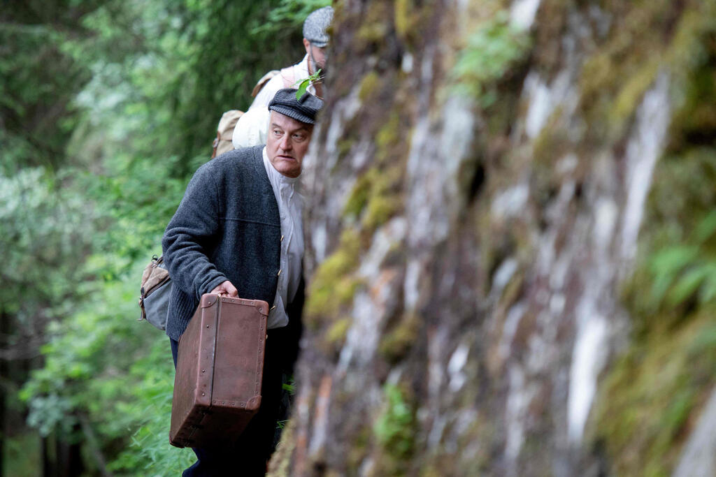 Director, actor and author of the theatre group Teatro Caprile, Andreas Kosek reenacts an emigration scene on the old Roman road in the Krimmler Tauern Alps on the border between Austria and Italy 