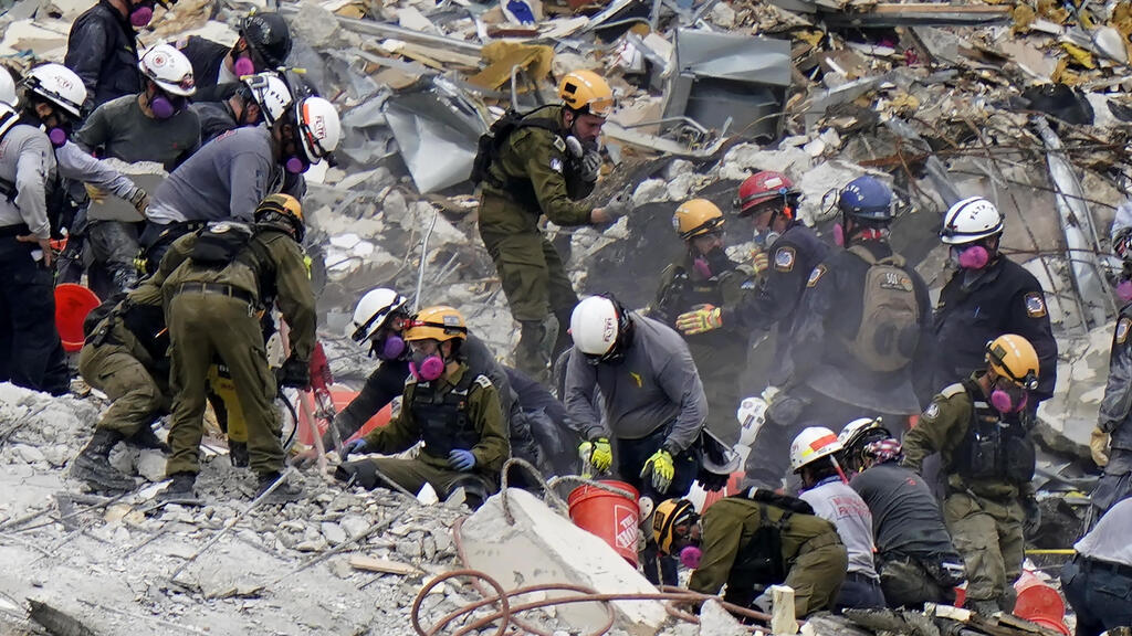 The Israeli rescue team looking through the rubble for survivors at the partially collapsed Champlain Towers South condo building in Surfside 