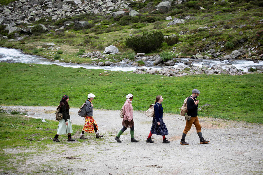 Actors of the theatre group Teatro Caprile reenact an emigration scene on the old Roman road on the Windbach Alp in the Krimmler Tauern Alps 
