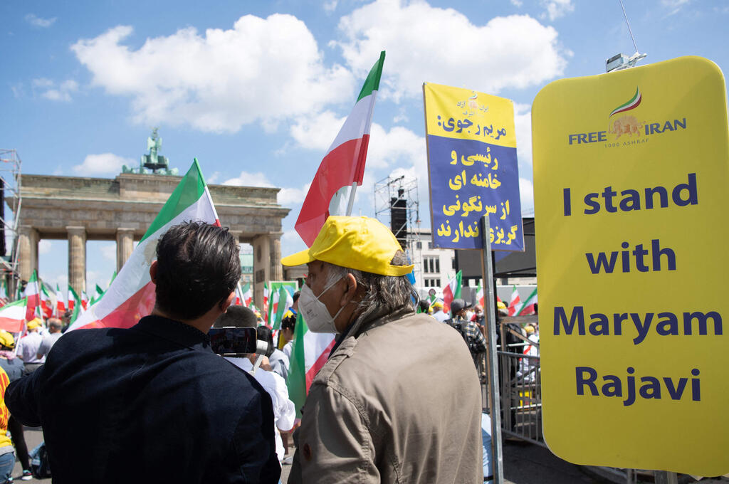 Demonstrators take part in a protest called by the National Council of Resistance of Iran (NCRI) against the Iranian regime in front of the Brandenburg Gate in Berlin on July 10, 2021