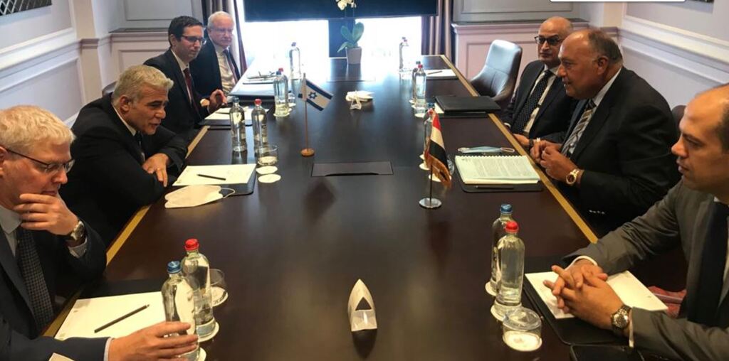 Foreign Minister Yair Lapid, left, meets with Egyptian counterpart Sameh Shoukry in Brussels, July 11, 2021