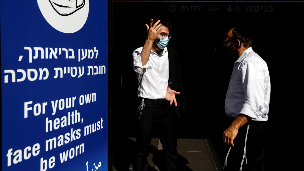 Men stand next to an information banner at Ben Gurion International Airport, amid a spread of the Delta variant near Tel Aviv (Photo: Reuters) Men stand next to an information banner at Israel's Ben Gurion International Airport, amid a spread of the Delta variant of the coronavirus disease (COVID-19), near Tel Aviv