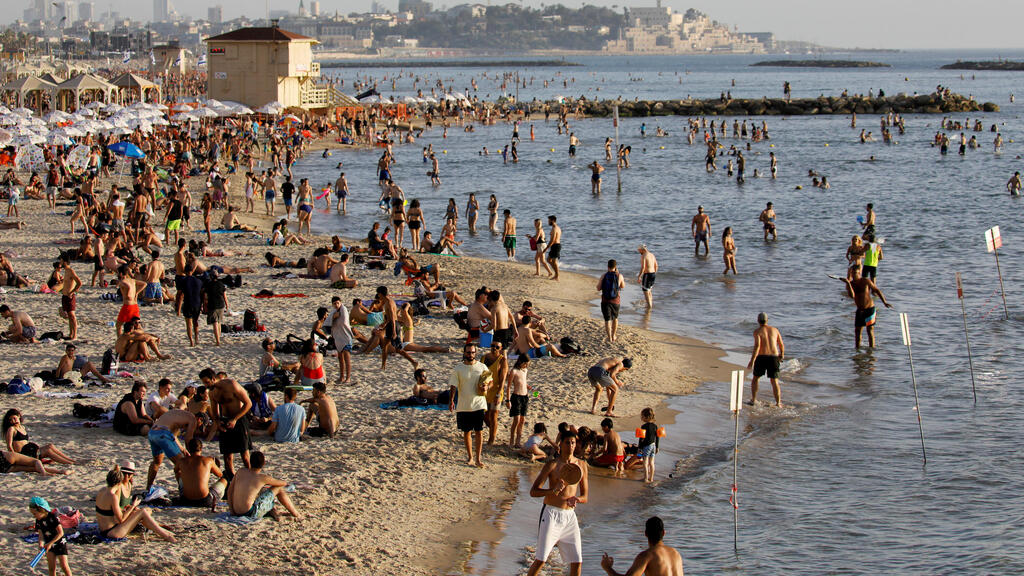 Beachgoers hang out on the shore of the Mediterranean Sea in Tel Aviv as coronavirus disease (COVID-19) restrictions eased in Israel May 21, 2020 