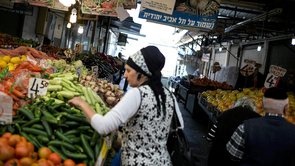  religious Jewish woman shops for vegetables at a market in Tel Aviv, Israel