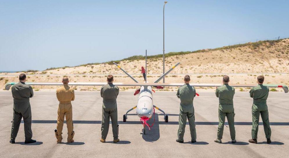 Drone pilots from five countries and Israel pose in front of a Hermes-450 