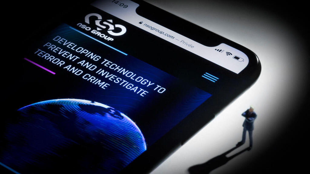 This studio photographic illustration shows a smartphone with the website of Israel's NSO Group which features 'Pegasus' spyware, on display in Paris on July 21, 2021 