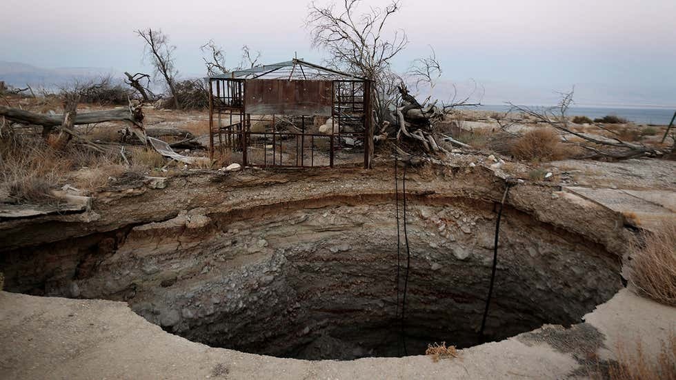 A large sinkhole is seen at the abandoned tourist resort of Ein Gedi along the shore of the Dead Sea 