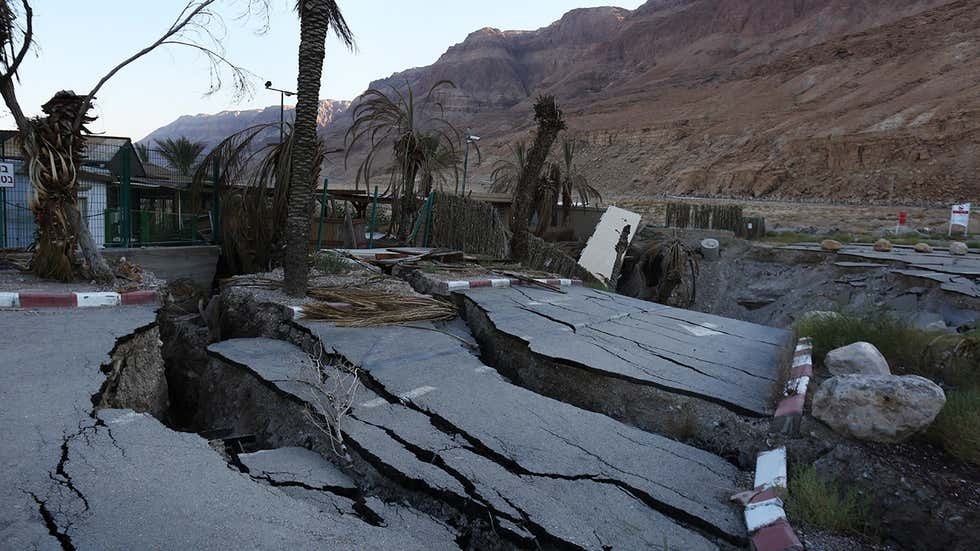 A view of a building that has collapsed into sinkholes in the abandoned Mineral Beach Resort on the shore of the Dead Sea 