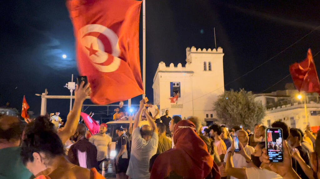 Crowds gather on the street after Tunisia's president suspended parliament, in La Marsa, near Tunis, Tunisia 