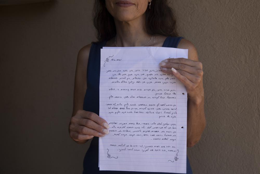 Idit Harel Segal, who donated a kidney to a Palestinian child from the Gaza Strip, holds with the letter she wrote to the boy, handwritten in Hebrew before giving him an Arabic translation 