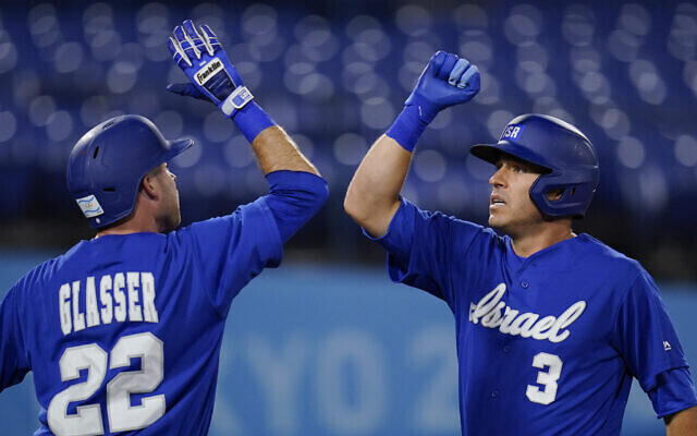 Israel’s Ian Kinsler (3) celebrates with Mitchell Glasser after hitting a home run in the third inning 