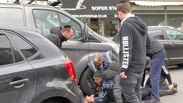 Men from the CST and Shomrim security units detain the alleged attacker of a Jewish man in his car in London, May 21, 2021