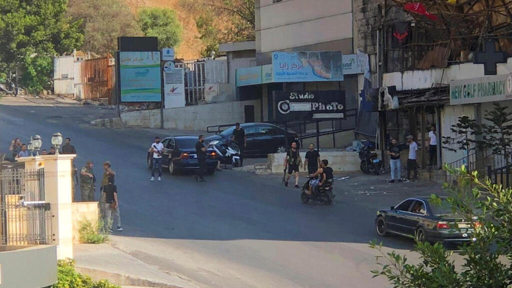 People stand in a street after an ambush on Shi'ite mourners in Khaldeh, Lebanon (Photo: Reuters) People stand in a street after an ambush on Shi'ite mourners in Khaldeh, Lebanon