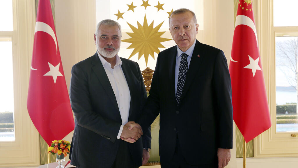 Turkey's President Recep Tayyip Erdogan, right, shakes hands with Hamas terrorist movement chief Ismail Haniyeh, prior to their meeting in Istanbul, February 1, 2020
