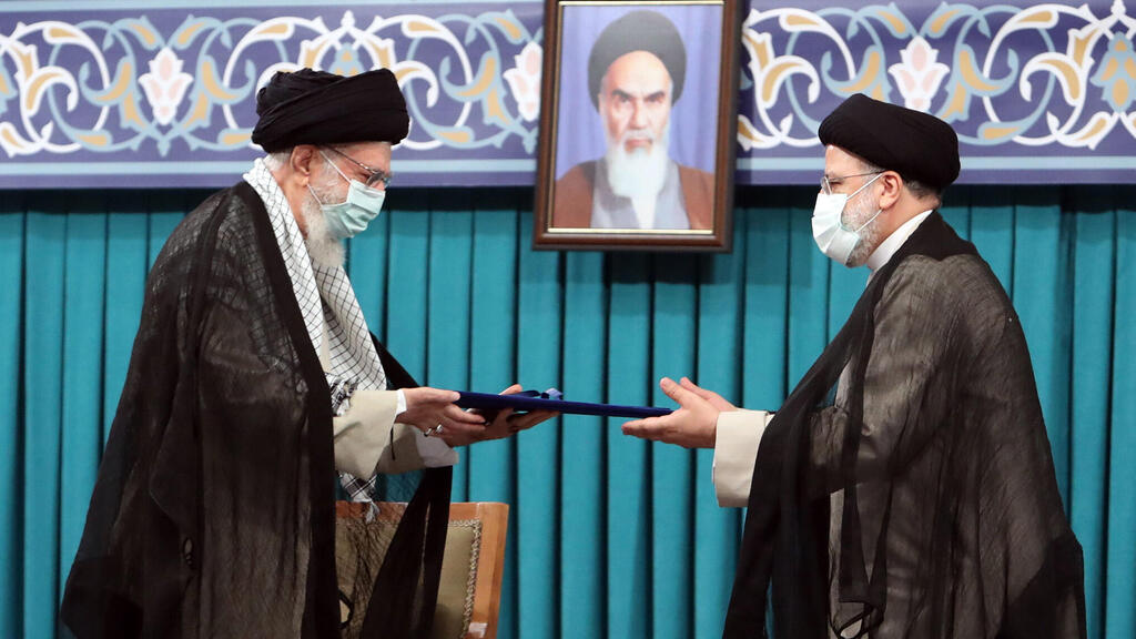 Iranian supreme leader Ayatollah Ali khamenei (L) handing over the presidential precept to new Iranian president Ebrahim Raisi (R), in Tehran, Iran 