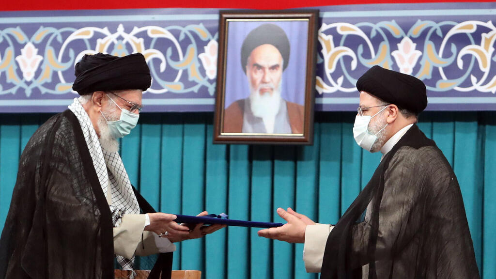 Iranian supreme leader Ayatollah Ali khamenei (L) handing over the presidential precept to new Iranian president Ebrahim Raisi (R), in Tehran, Iran 
